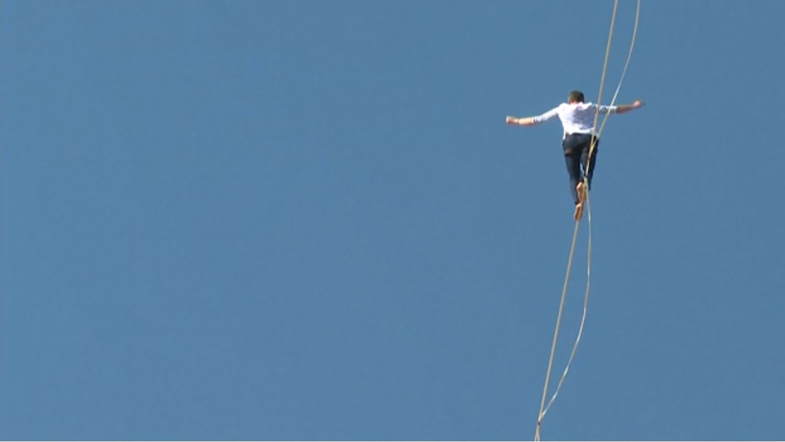 World record holder French adventurer walking on a rope between two peaks .. Video